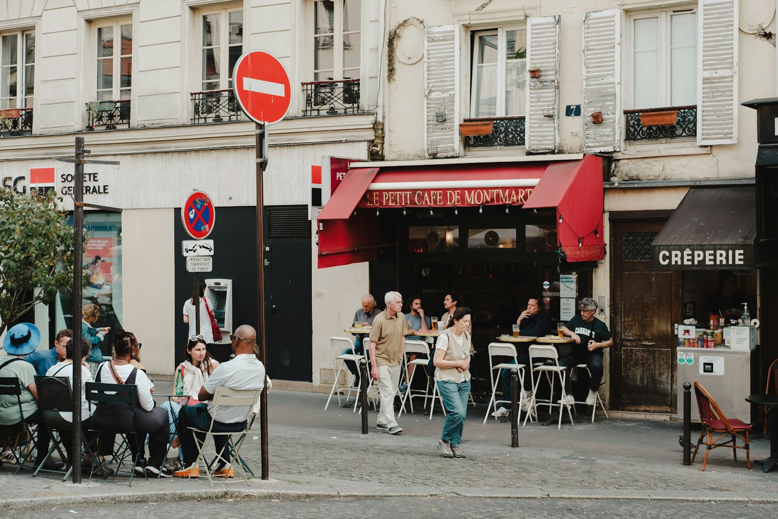A busy Paris cafe terrace full of people on a sunny day